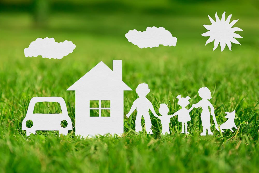 Cut Out of paper Family With House And Car On Green Grass